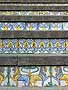 Tiles at the foot of the steps, with lions and repeating swirl designs