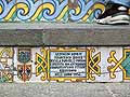 A commemorative plaque and surrounding tiles