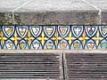 Sheilds with different motifs make up this row of four tiles