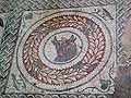 Bull's head mosaic in a laurel wreath