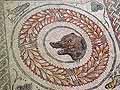 Bear's head mosaic in a laurel wreath