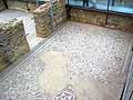 A guest room with geometric mosaic floor