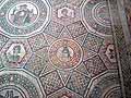 A mosaic emblem  within a complex pattern of triangles, squares, hexagons and dodecagons